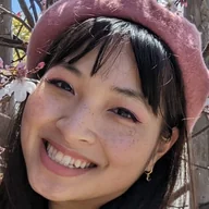 Denise Ngo smiling in a pink beret